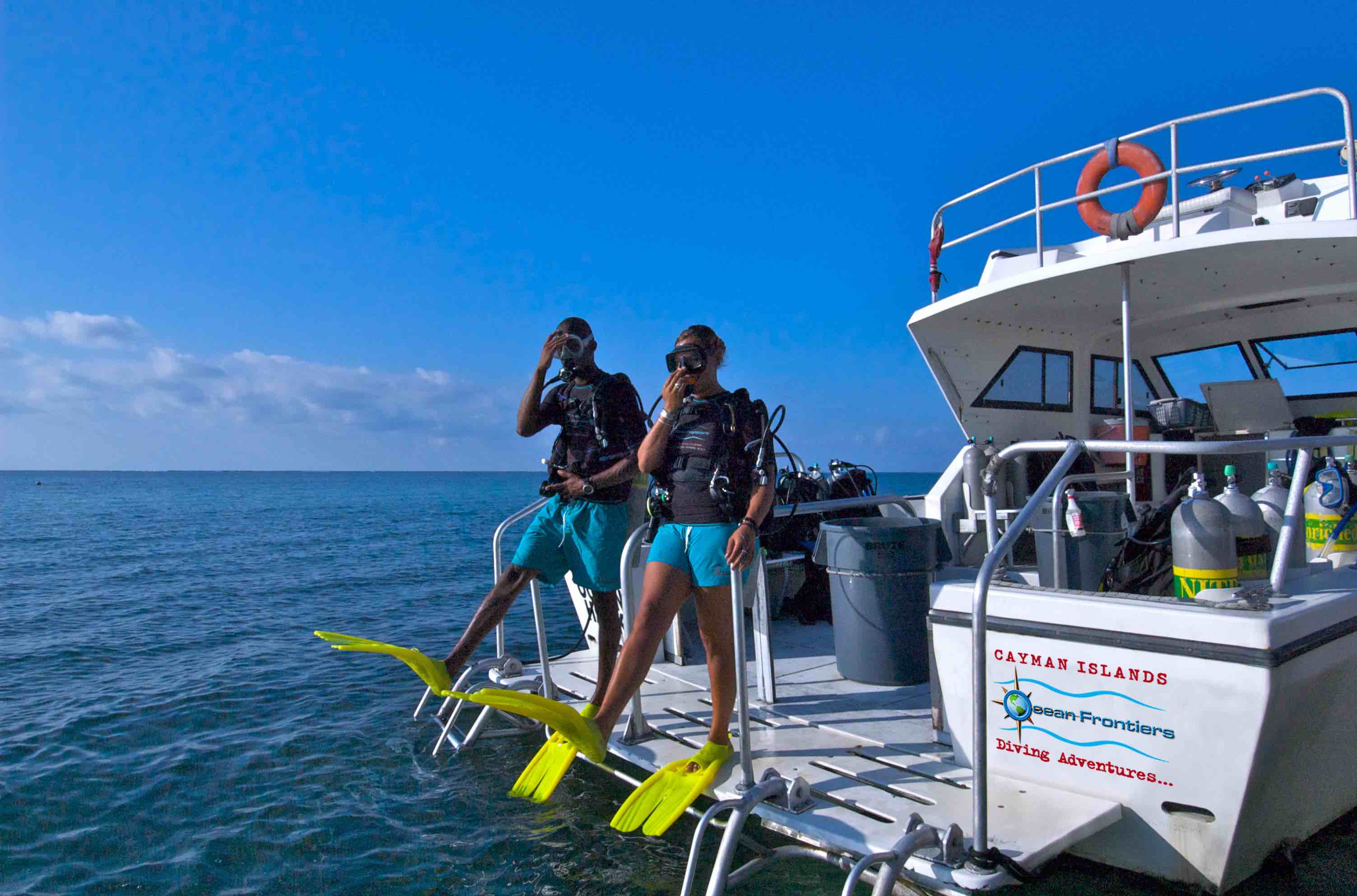 Divers getting ready to jump off a dive boat